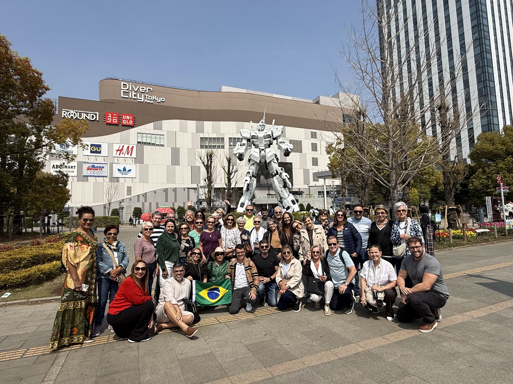 Grupo da Rigue em Odaiba com o Gundam ao fundo durante a viagem ao Japão